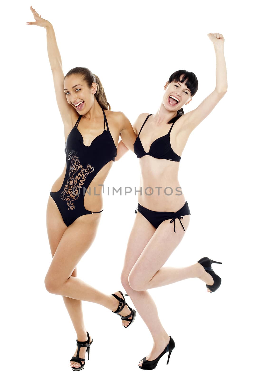 Sexy bikini ladies in joyous mood rejoicing together. Isolated against white background