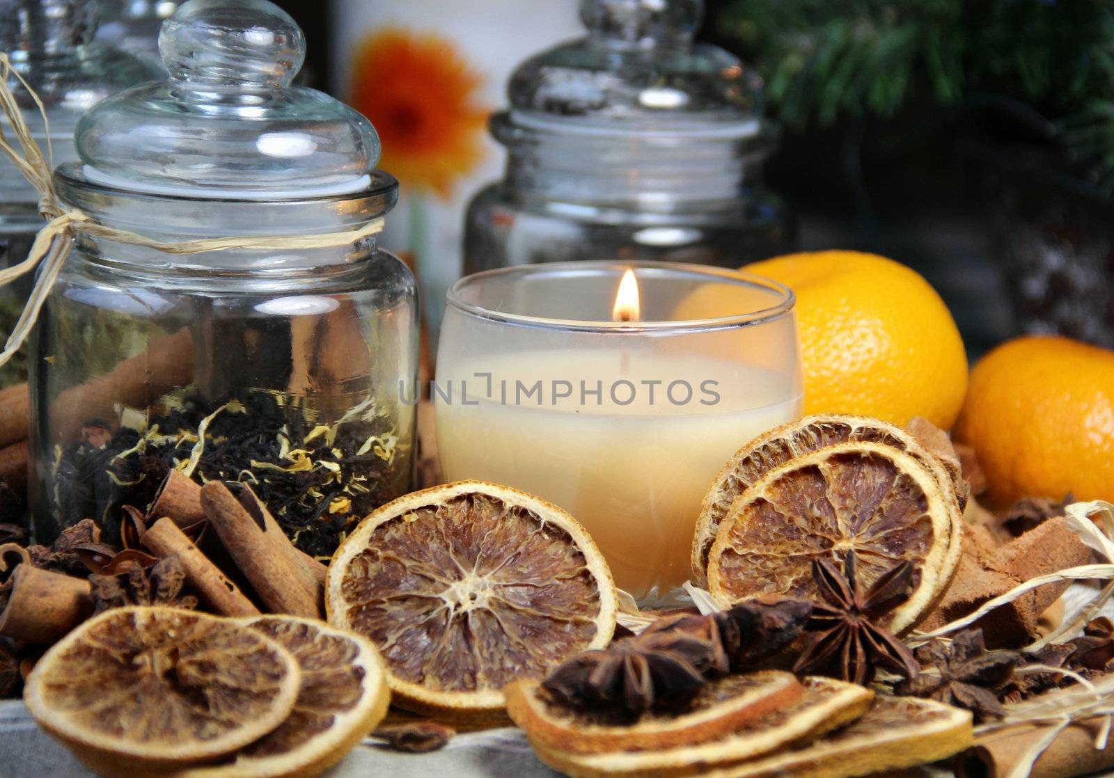 Candle, cinnamon sticks and dry orange by tanouchka