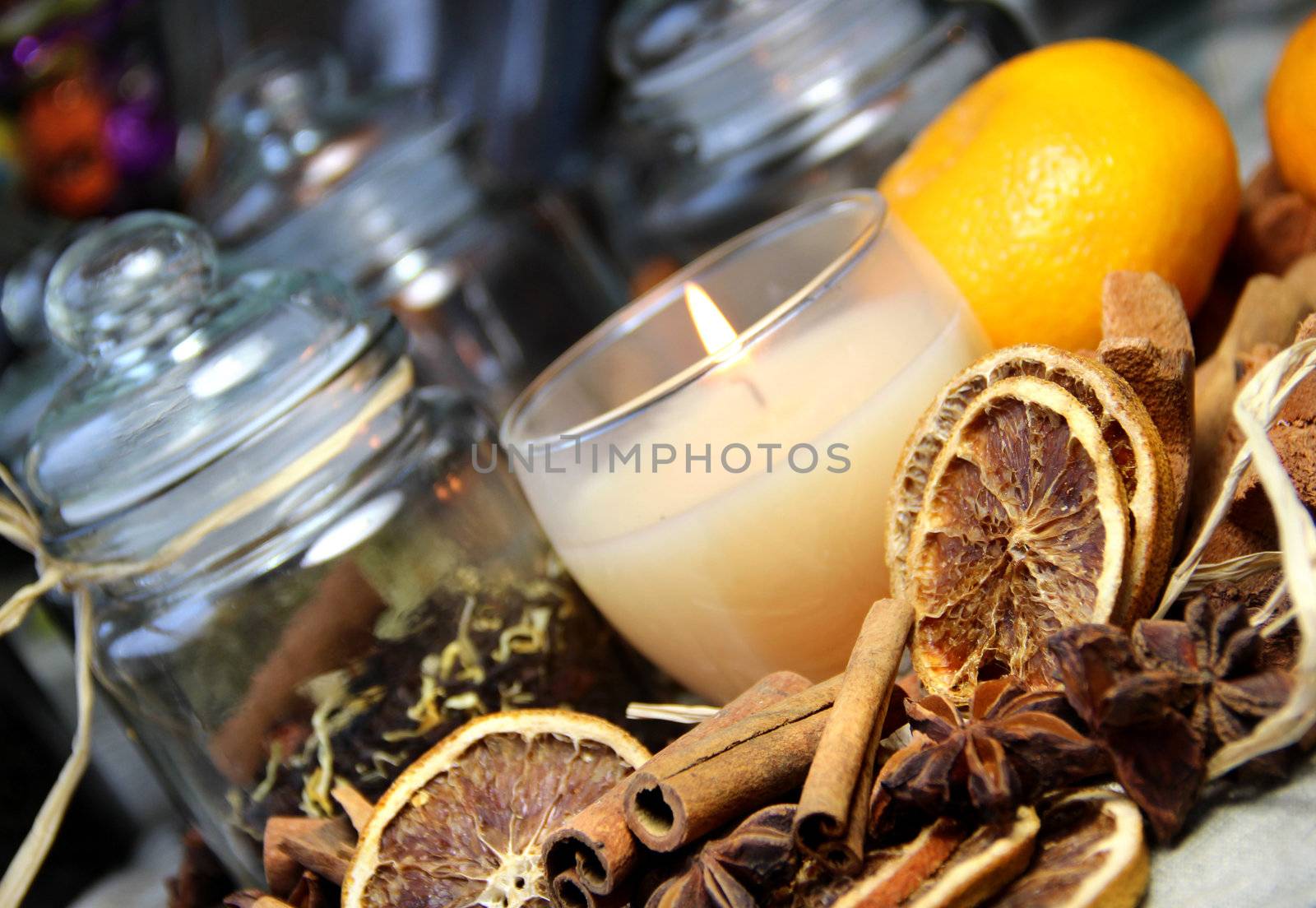 Candle, cinnamon sticks and dry orange by tanouchka