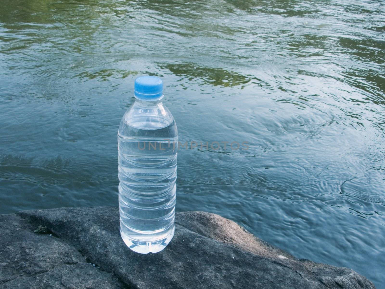 pet bottle of pure drink on the clean blue water stream background