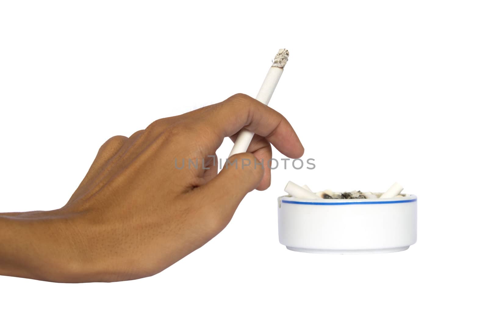 Isolated hand and ceramic ashtray with cigarettes.