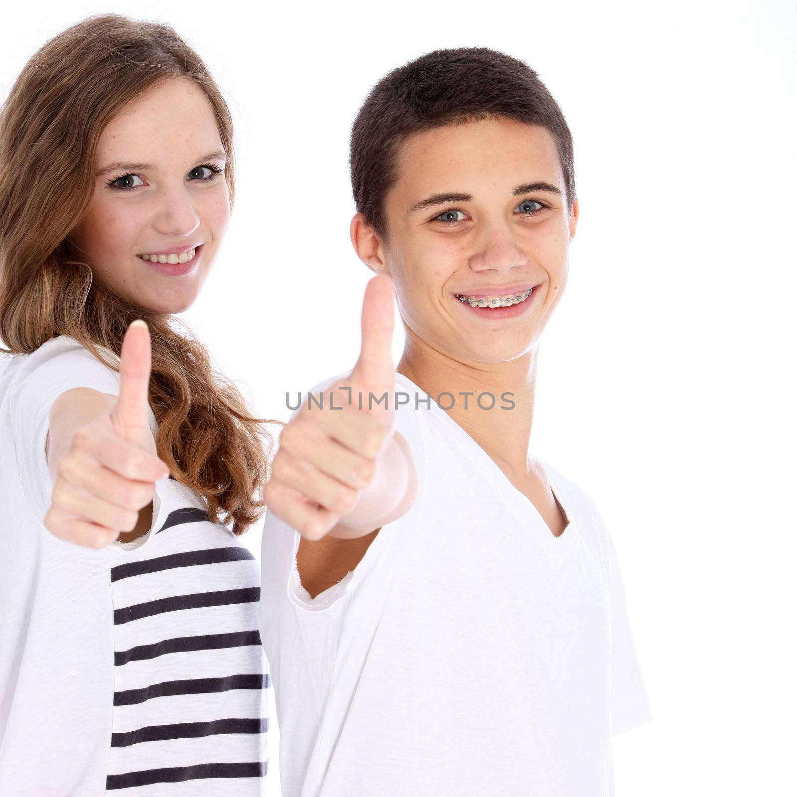 A happy teenage boy and girl giving a thumbs up of success and approval isolated on white A happy teenage boy and girl giving a thumbs up on success and approval isolated on white