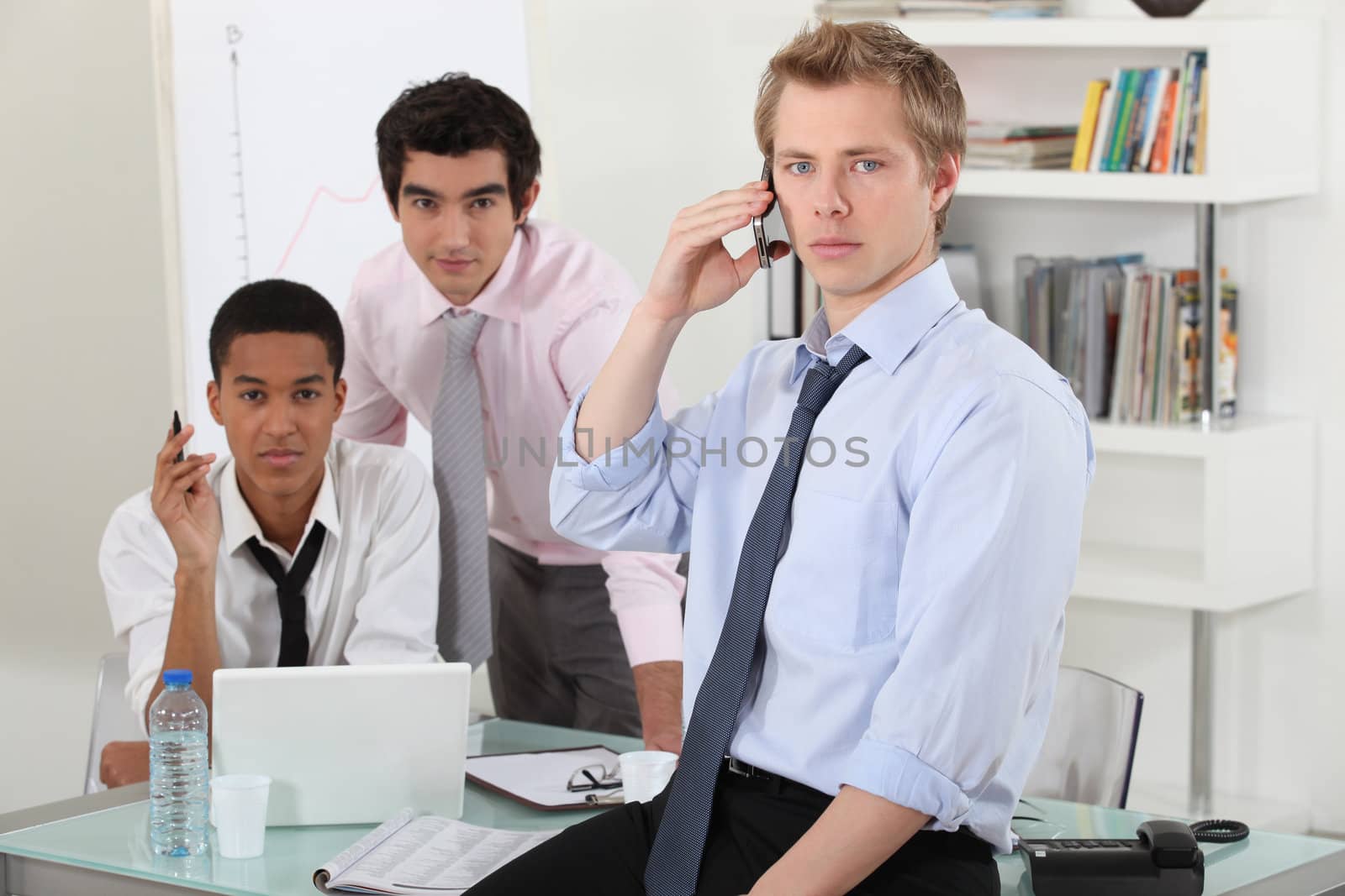Three businessman working on a project.