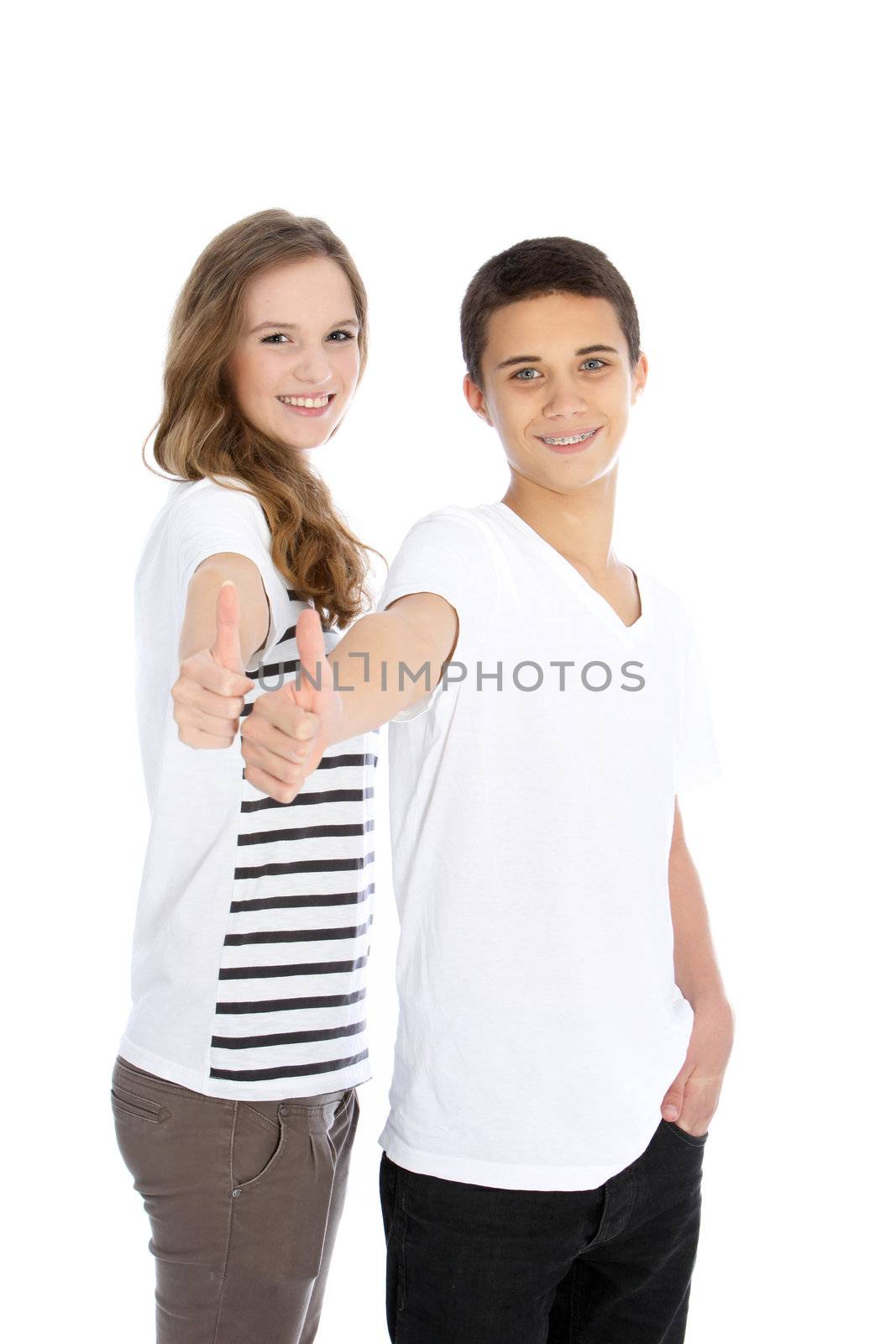 Three quarter studio portrait of an attractive young teenage brother and sister giving a thumbs up gesture isolated on white