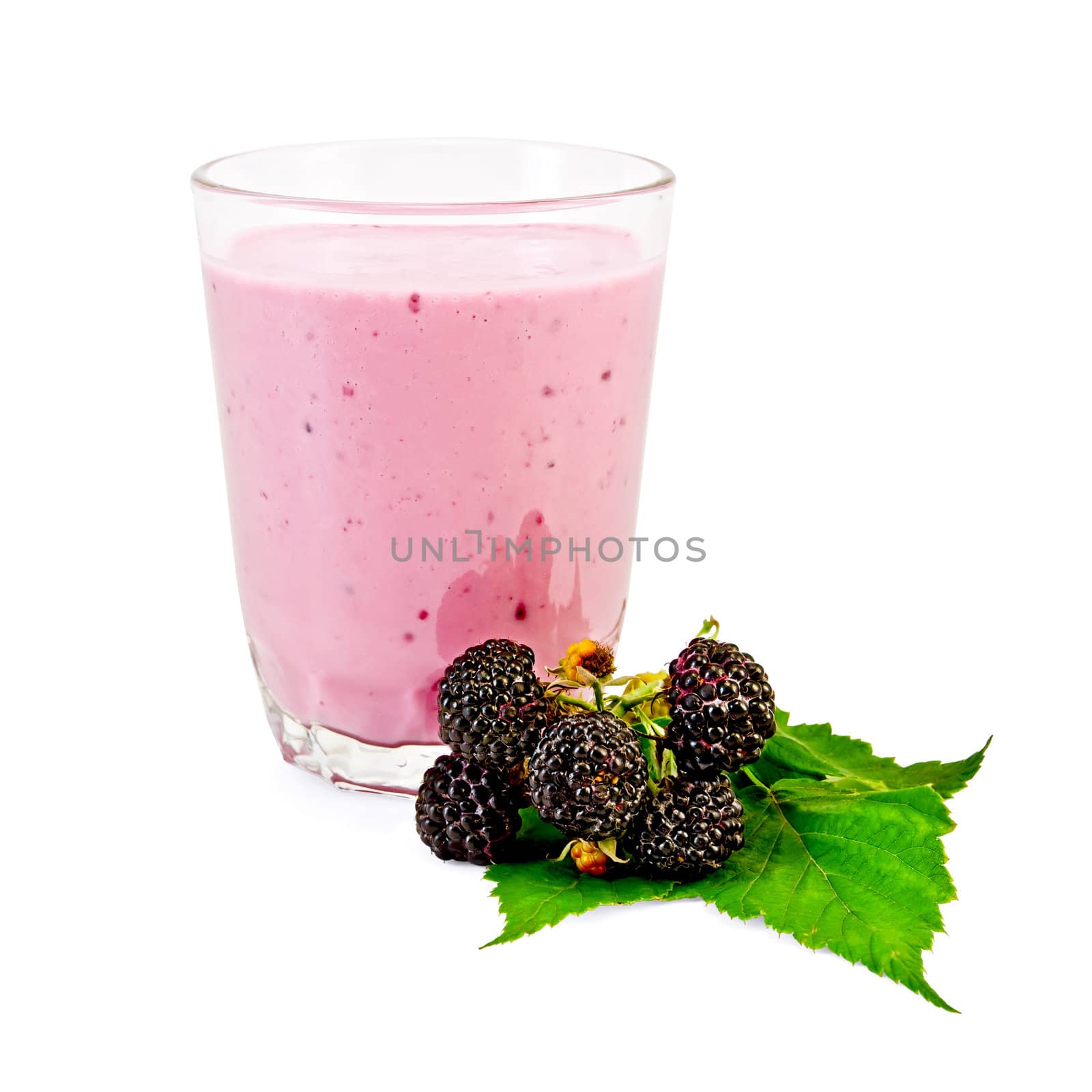 Glass with milkshake, berries and a green leaf of a blackberry it is isolated on a white background