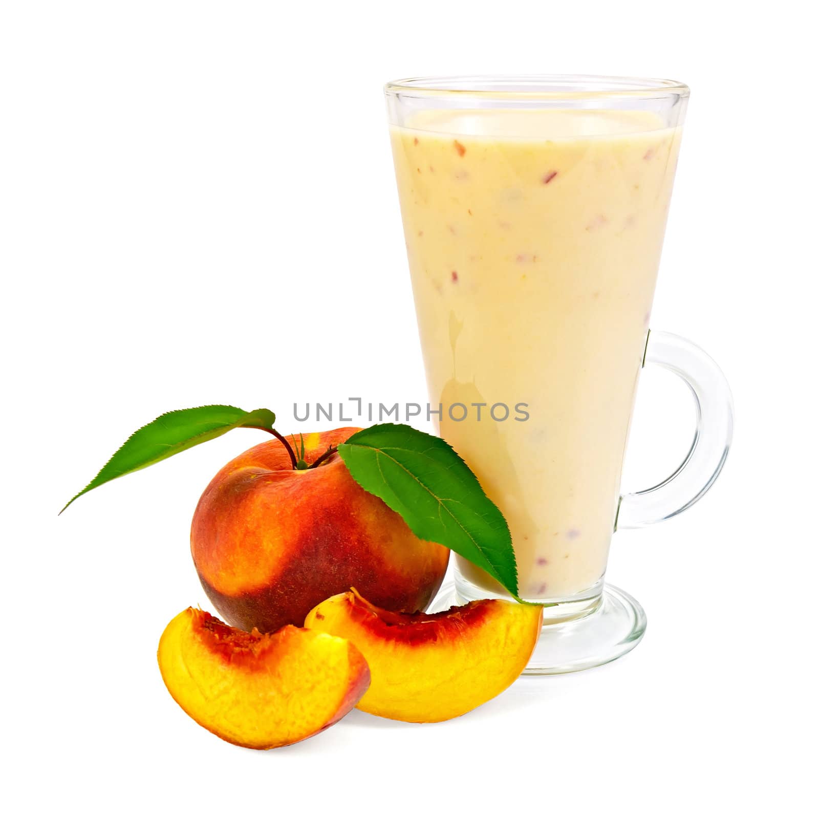 Milkshake in a glass beaker with peaches and green leaves it is isolated on a white background