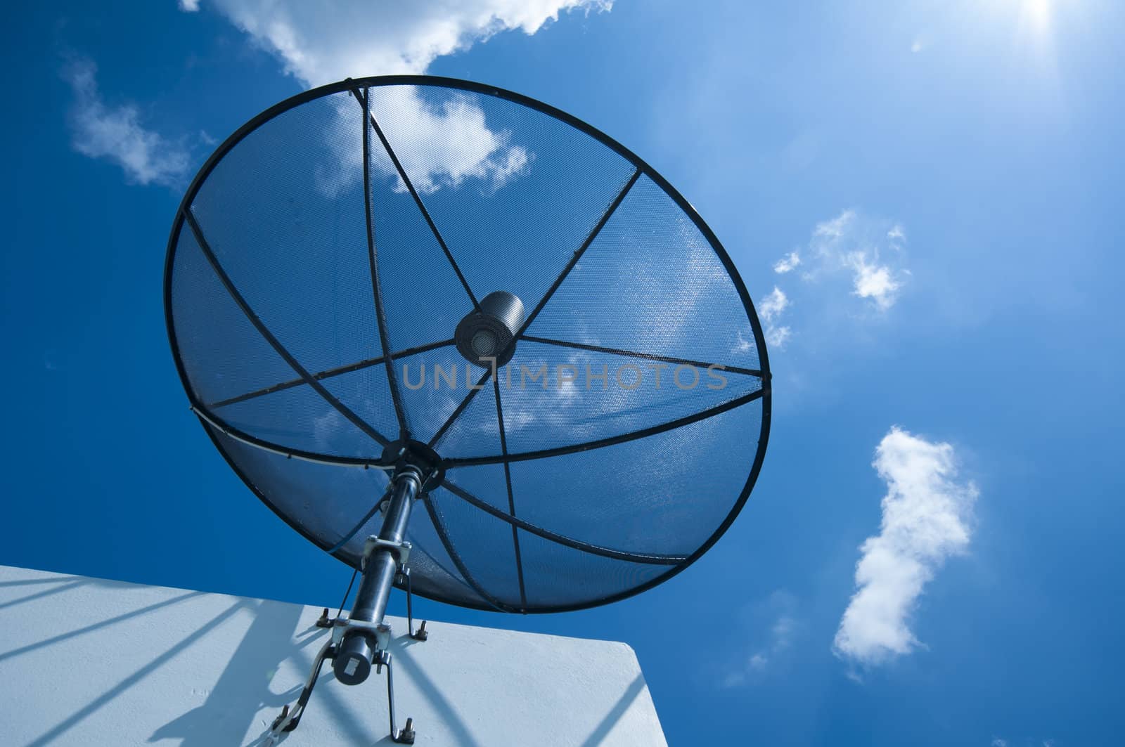 Satellite dish on cloudy blue sky