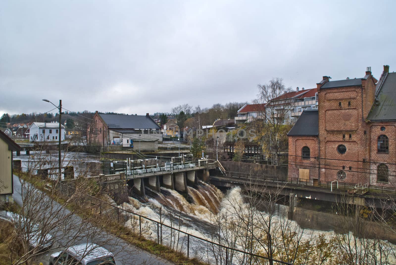 tistedal waterfall also called tista begins in tistedal which is a village in halden municipality and flows out from a lake called femsjøen (five lake), and from there it falls 66 meters on its way to halden center, image shows the first part of the falls where it plunges out of femsjøen (five lake), former lay many sawmills along the river tista, image is shot in november 2012.