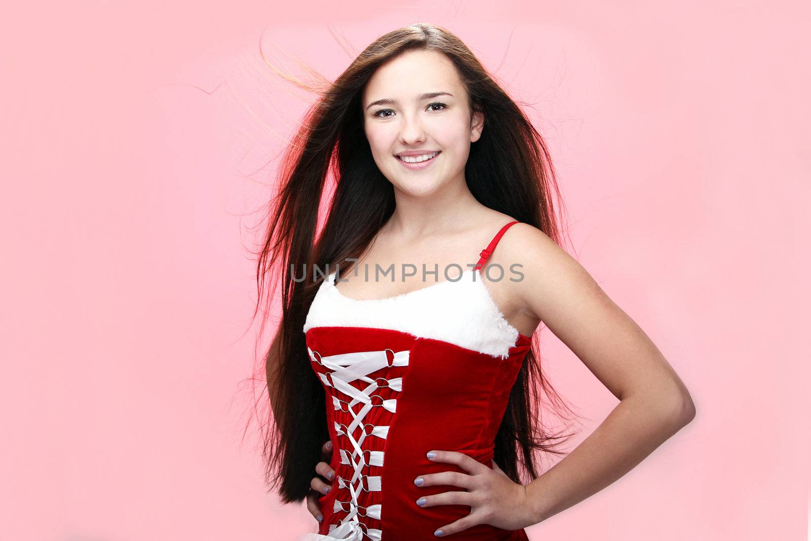 Portrait of young and beautiful smiling christmas girl in red