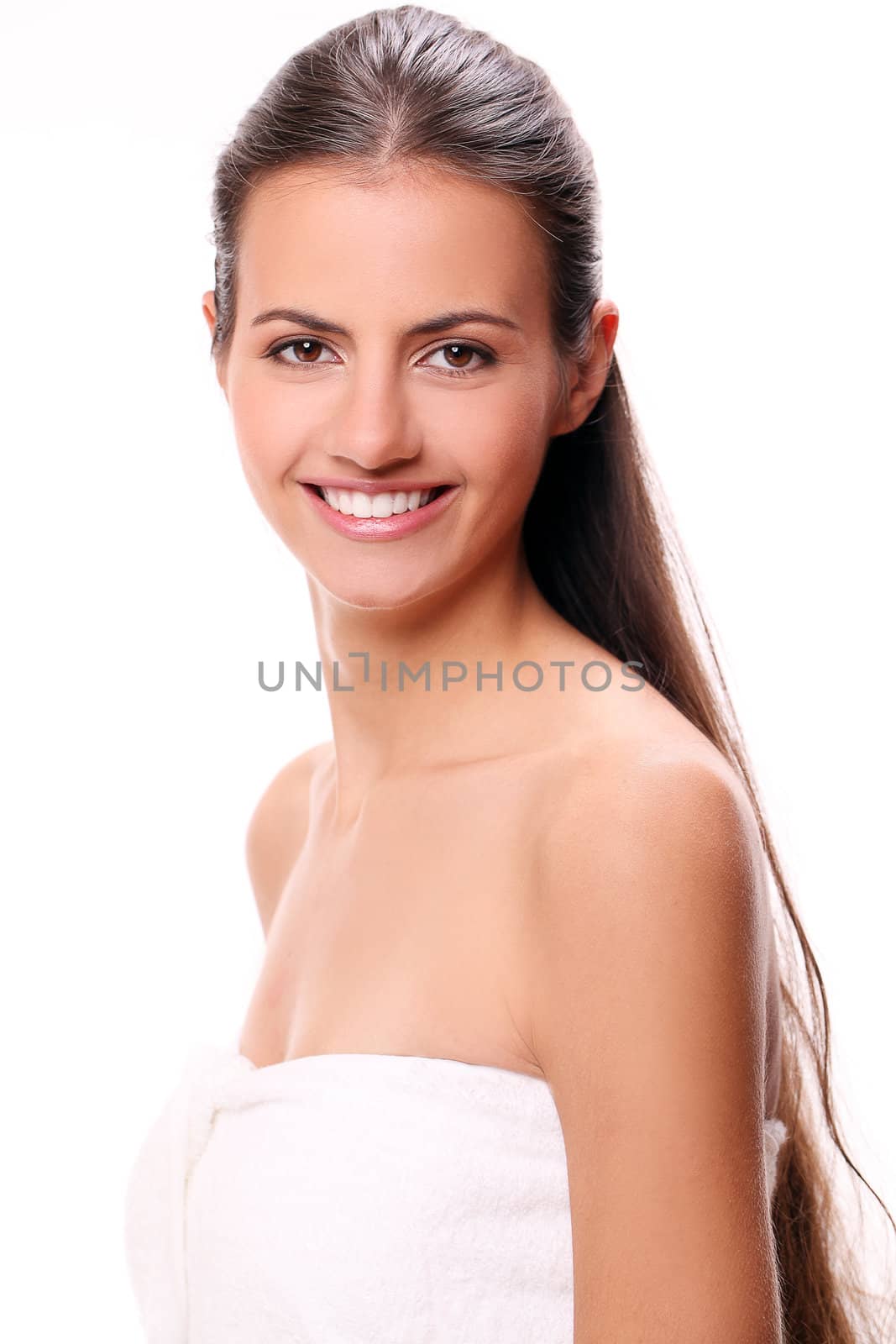 Portrait of beautiful smiling woman with cute smile in towel
