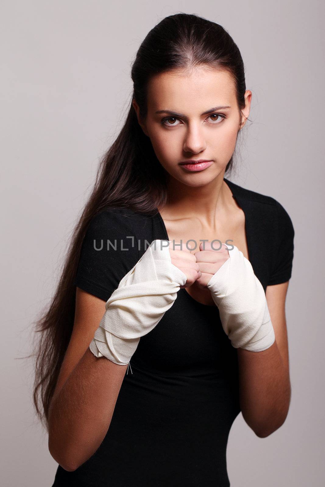 Portrait of beautiful woman with bandages ready for a fight