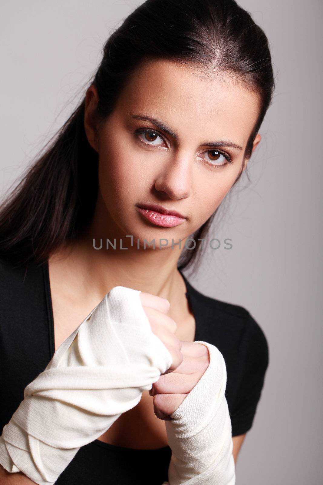 Portrait of beautiful woman with bandages ready for a fight