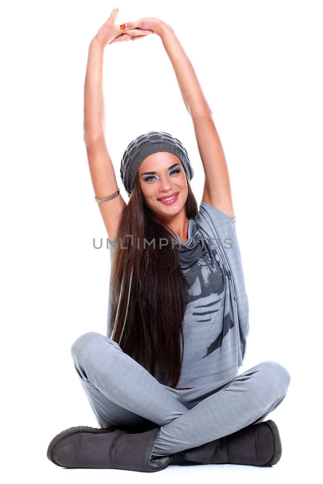 Cute and modern woman in hat sitting over a white background