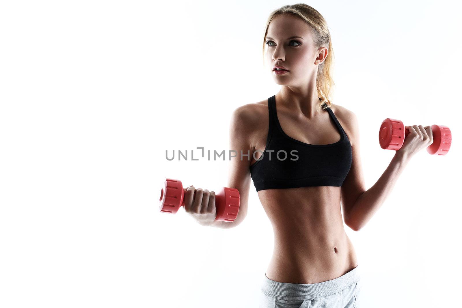 sporty and attractive woman do exercise with red dumbbells