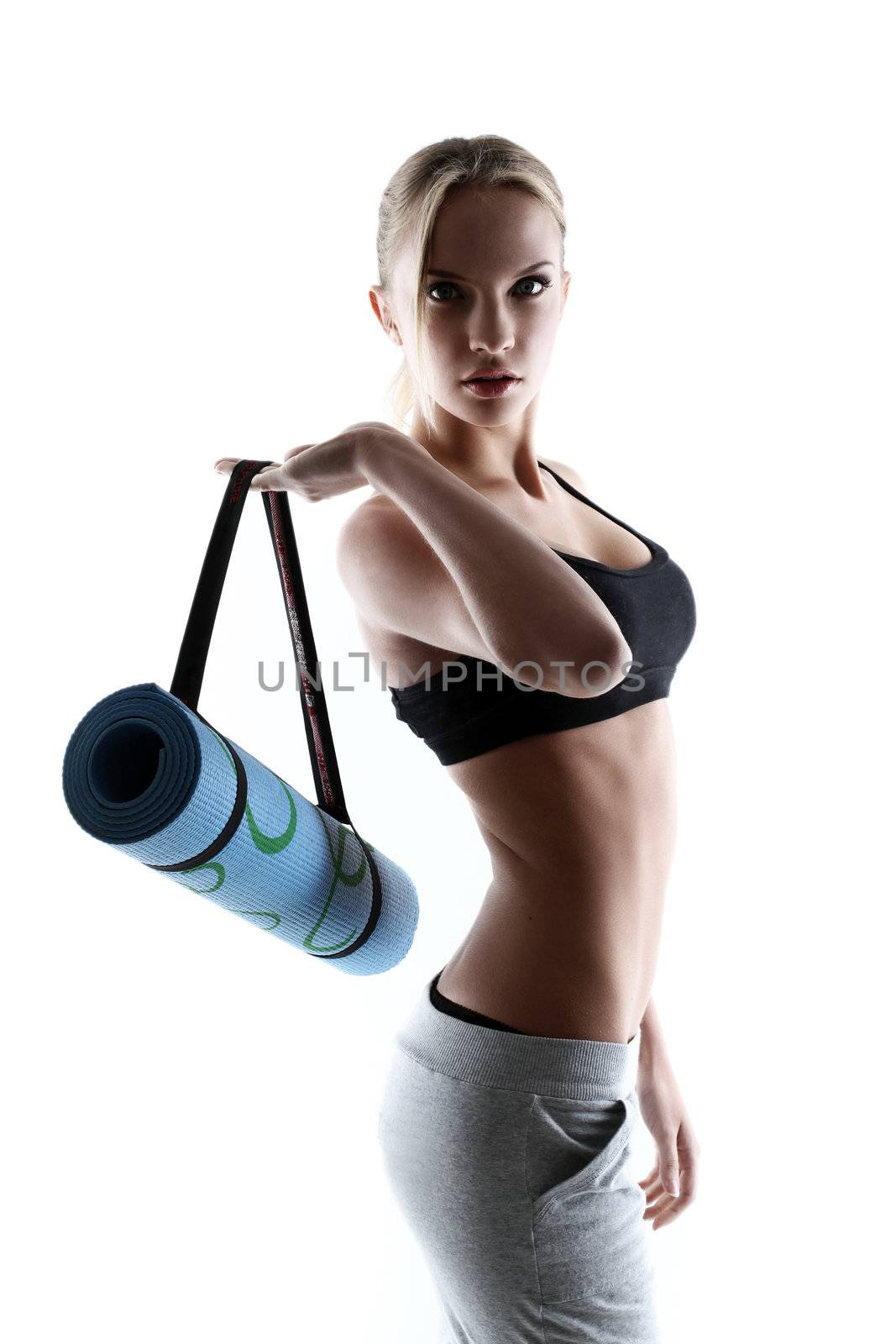 sporty and attractive woman with blue mat isolated on a white