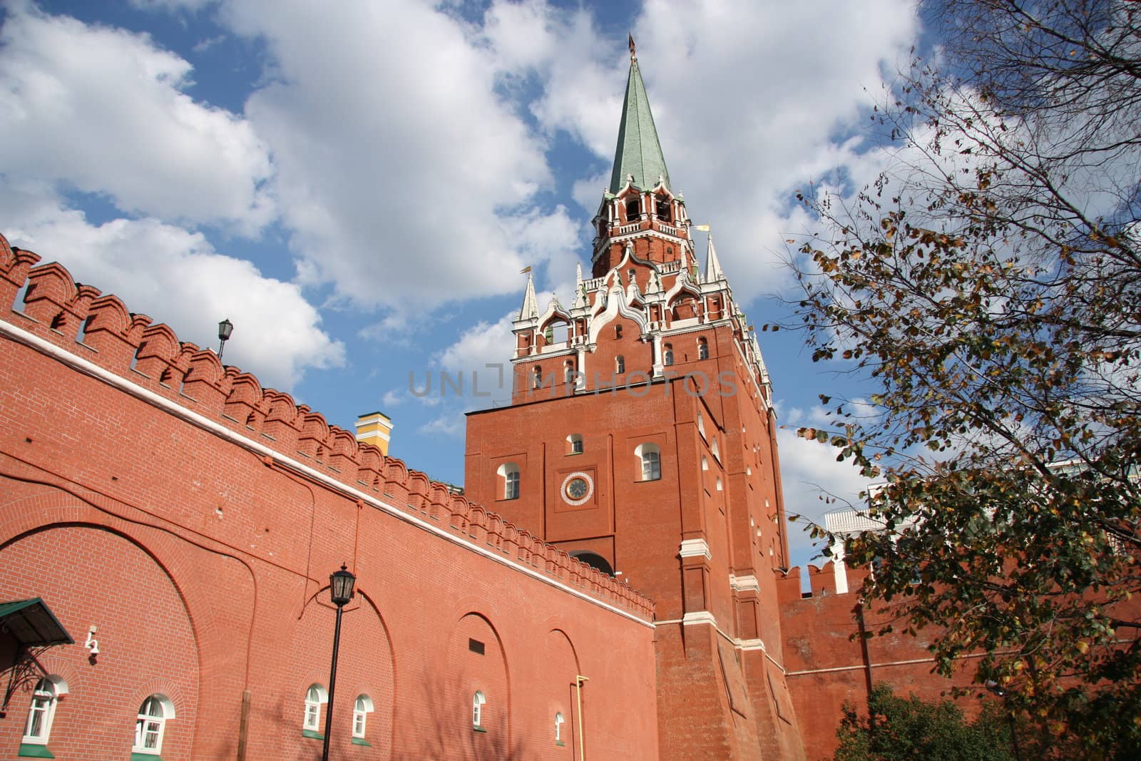 Moscow Kremlin wall and the Troitskaya tower over blue cloudy sky, Moscow, Russia