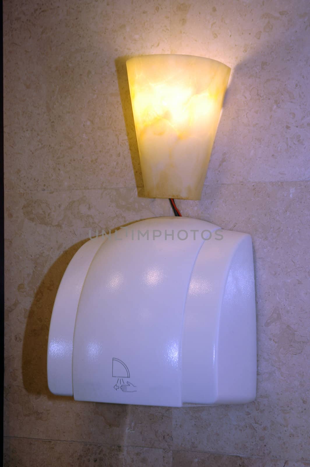 hand dryer on the wall at washrom by antonihalim