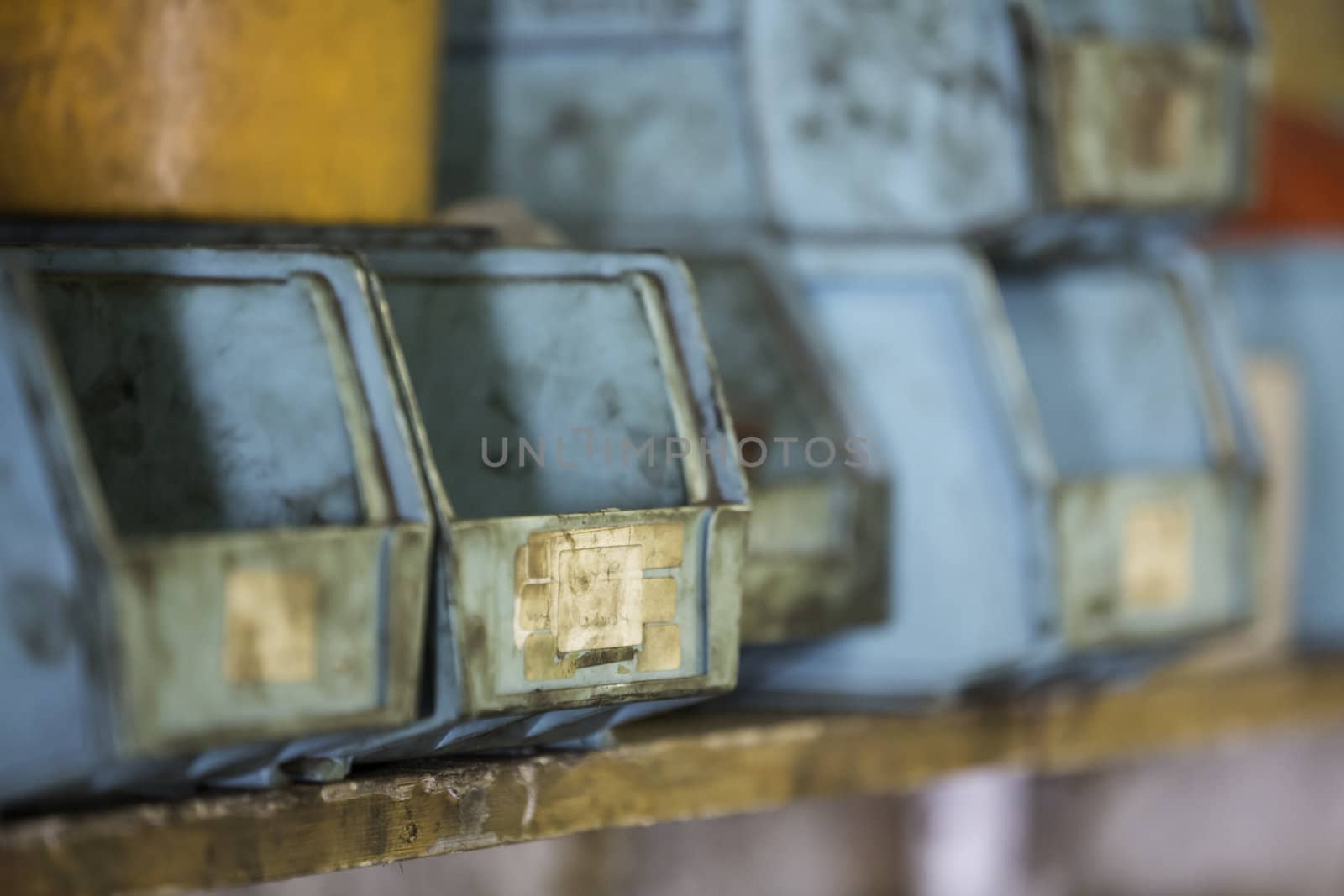 Closeup of plastic storage containers on a garage shelf with intentional shallow depth of field