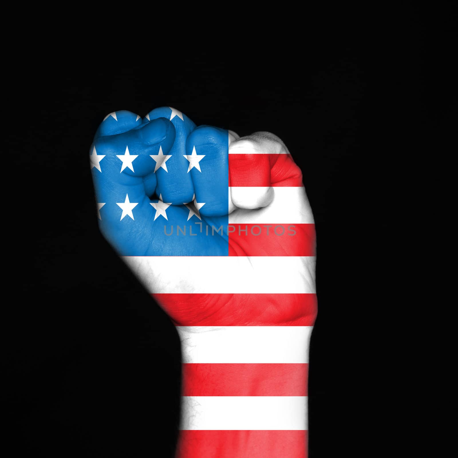 Low key picture of a fist painted in colors of american flag