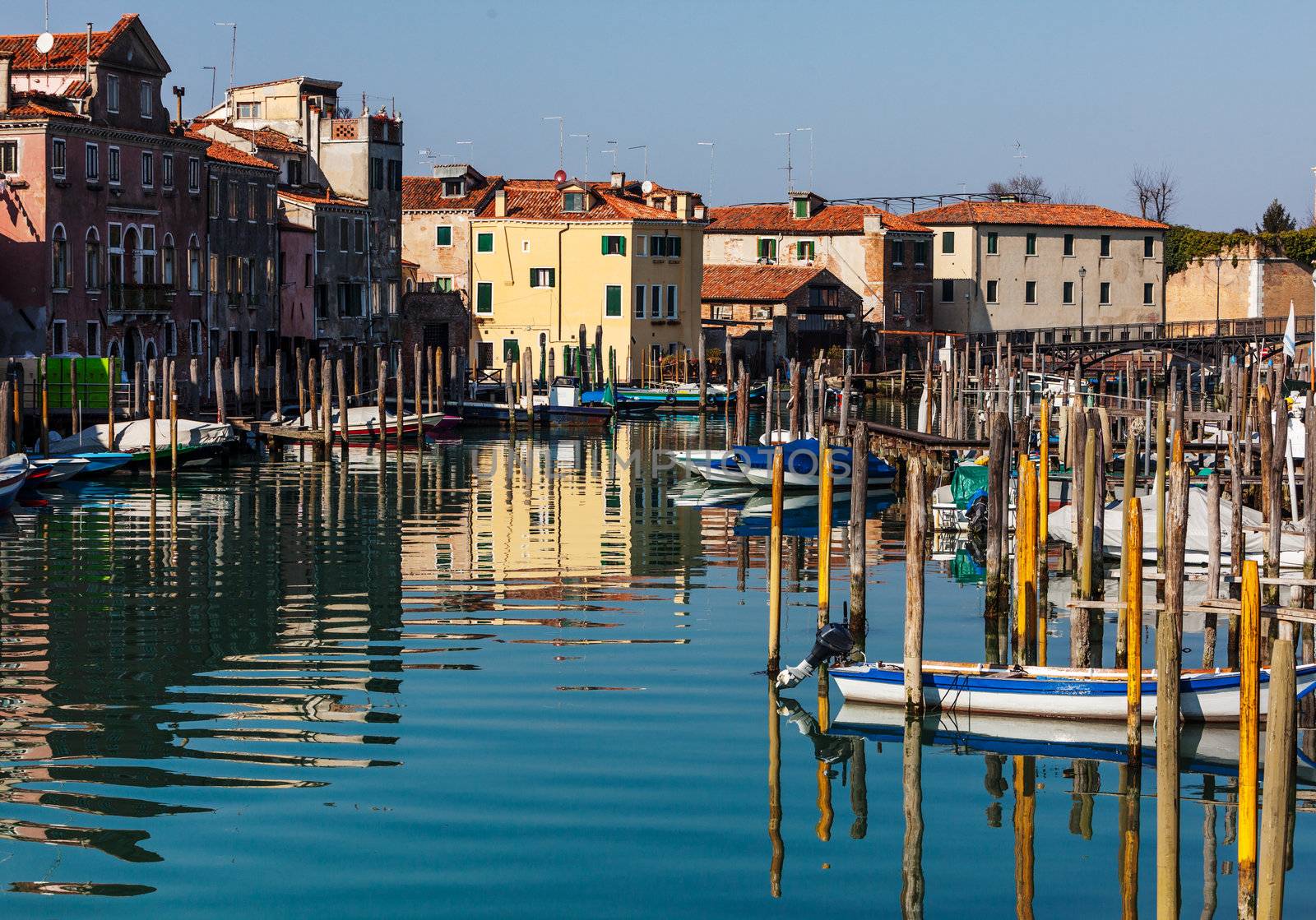 Townscape with a canal , a smal port and beautiful water reflections located in Venice,Italy.