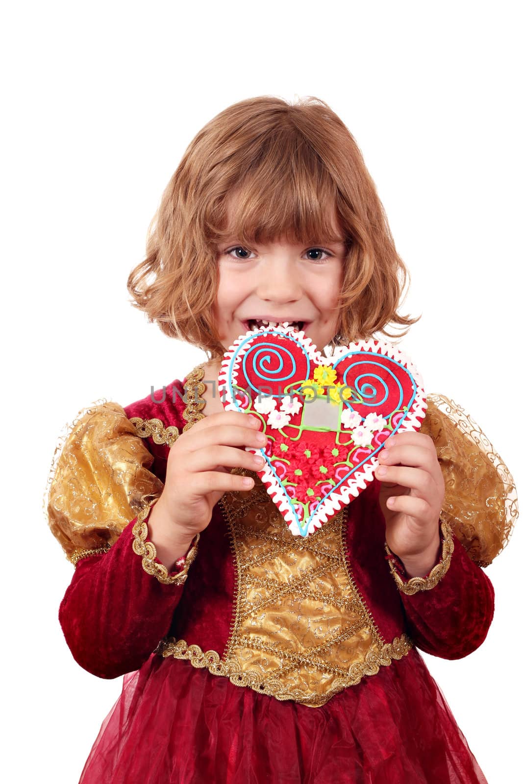 little girl eating gingerbread heart