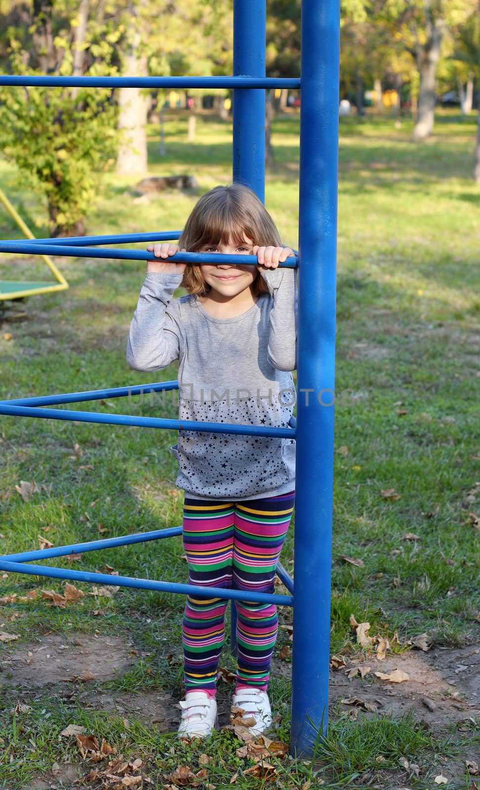 little girl hiding on playground