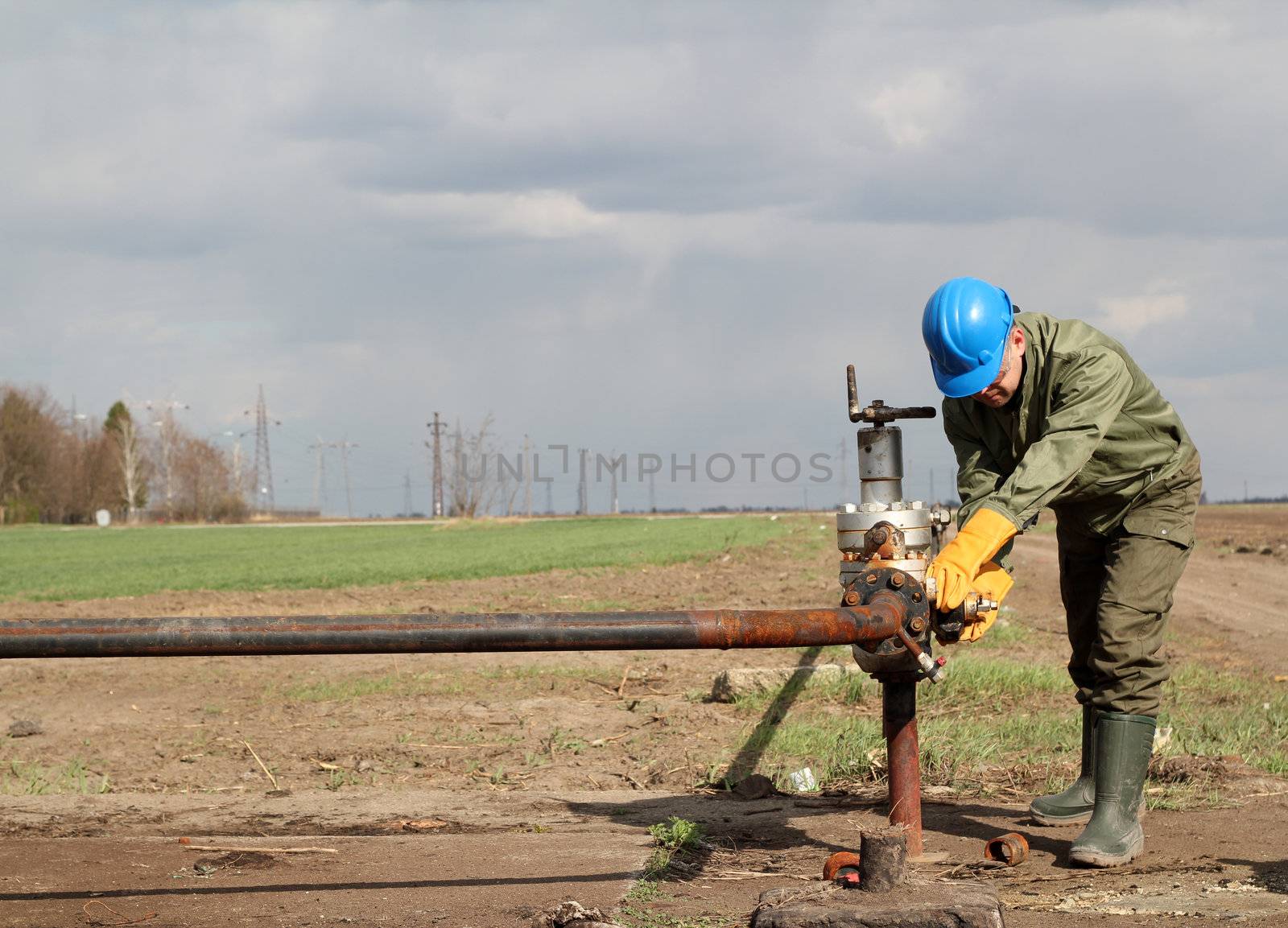 oil worker closes the valve