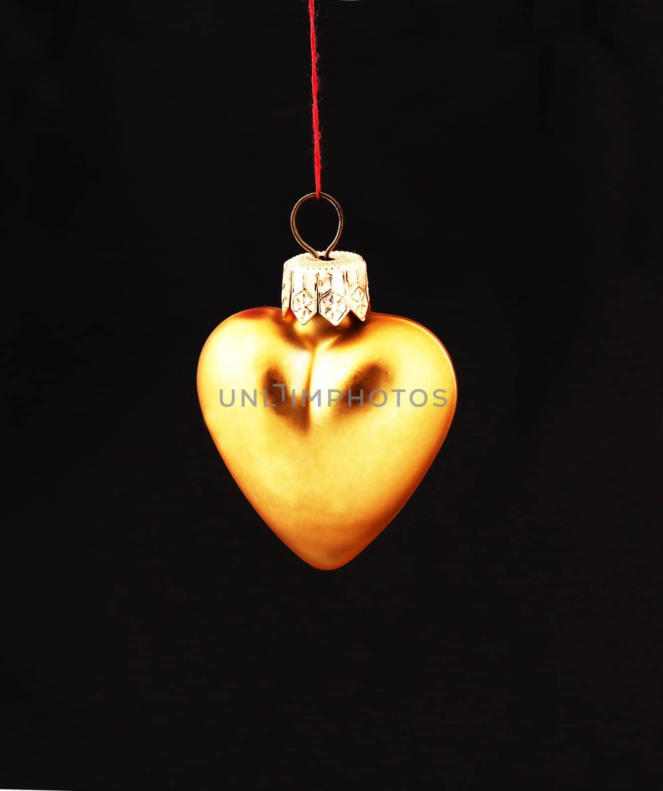 Hanging Christmas yellow heart  isolated on black background