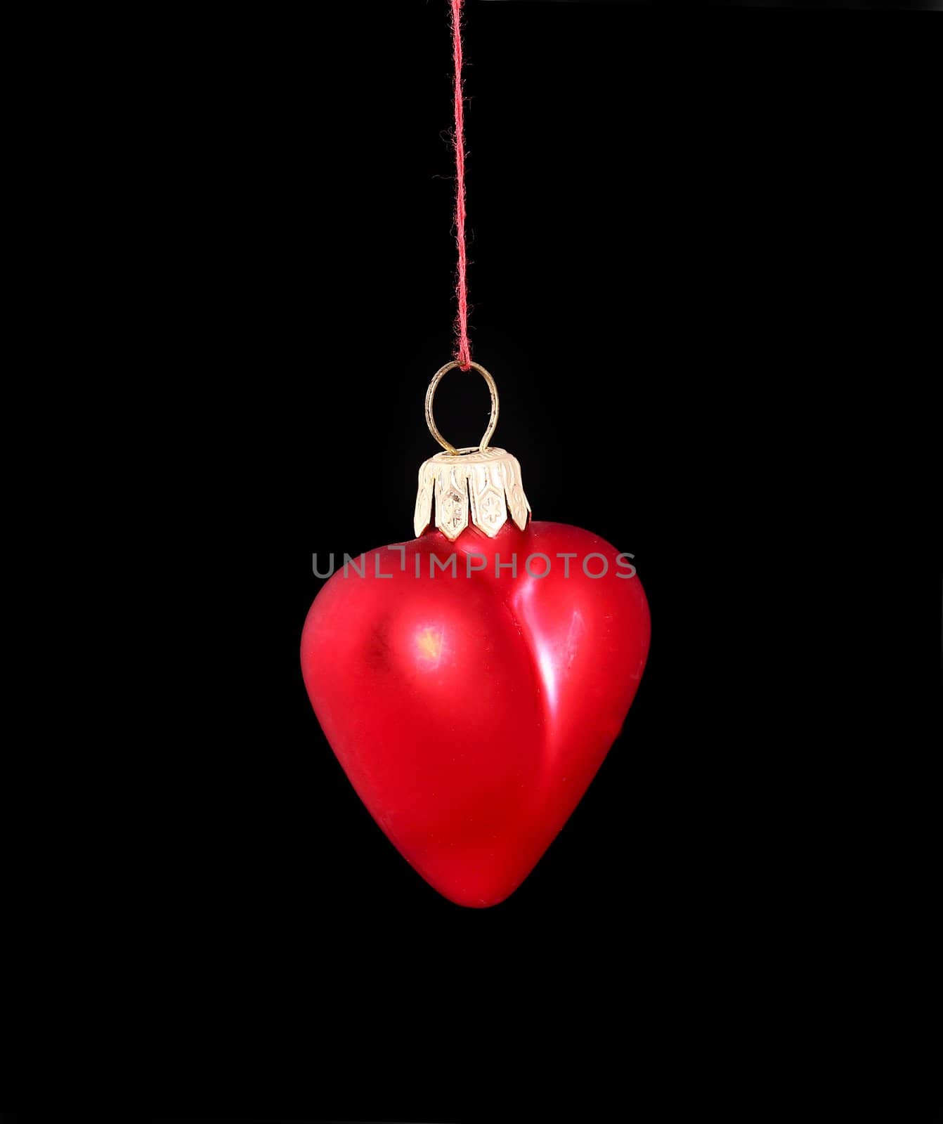 Hanging Christmas red heart  isolated on black background