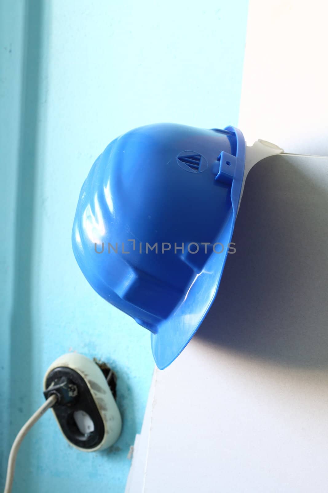 Blue helmet  close up on work place 