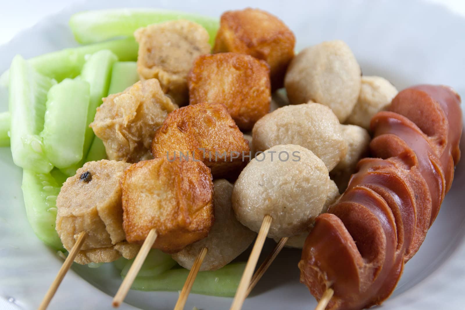 Meat Ball and sausage fried on white dish.