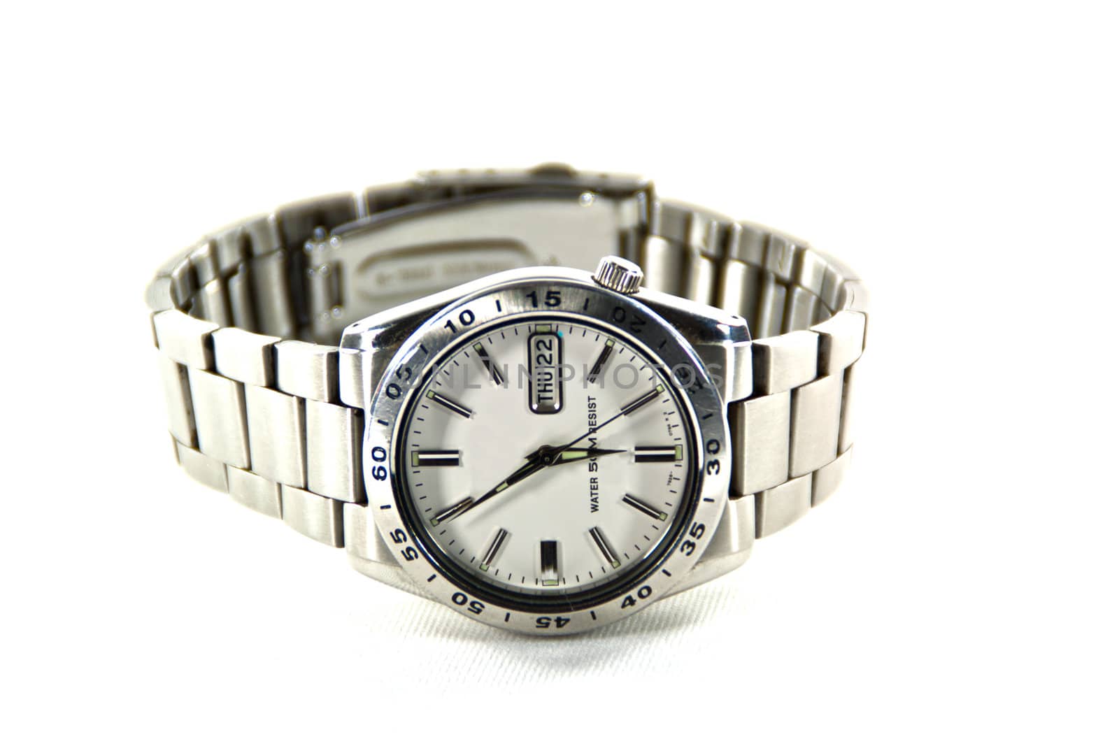 Silver wristwatch and white face on white backgroud.