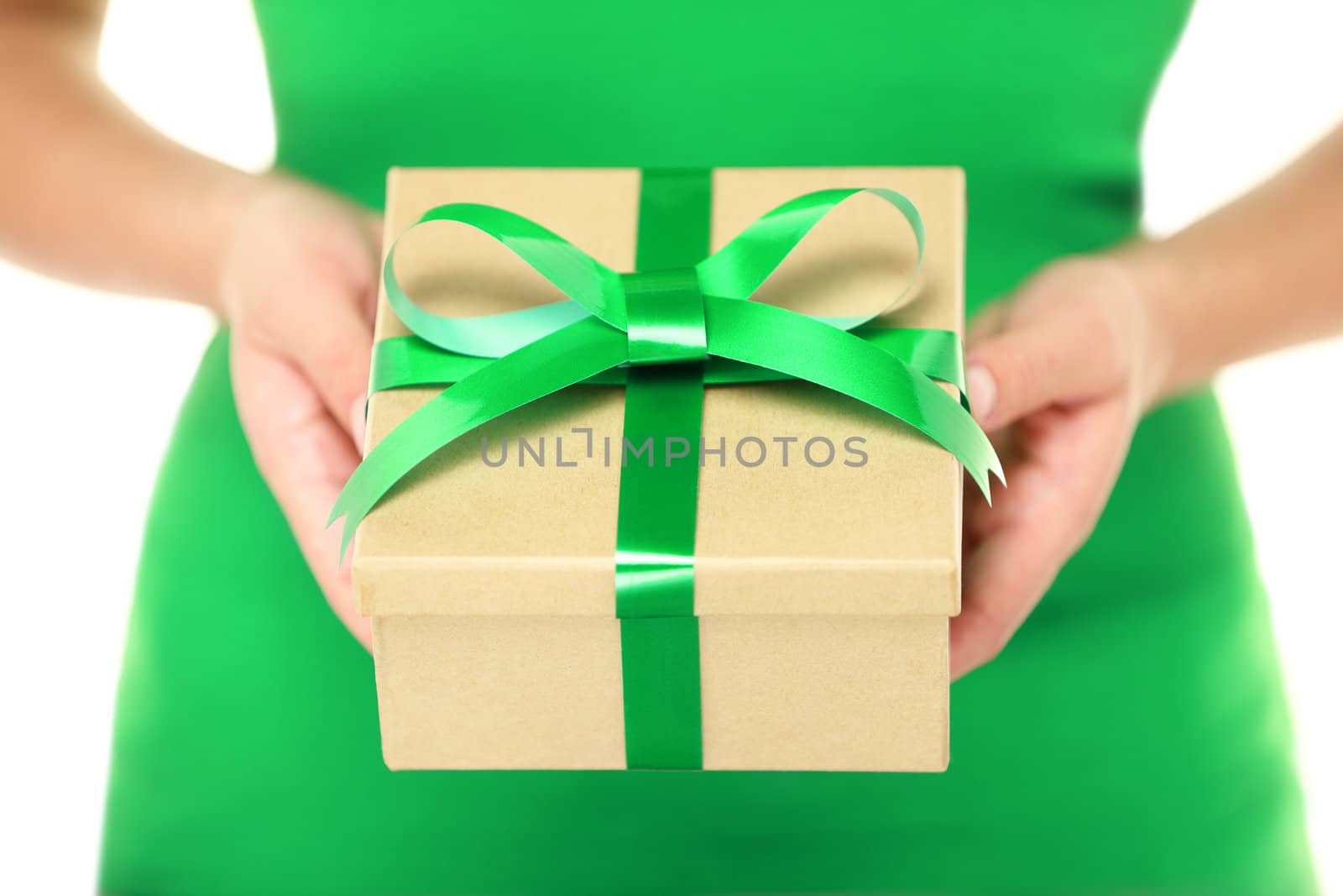 Gift / present. Woman hands showing and giving gifts. Closeup of present made of recycled carton and green ribbon on white background.