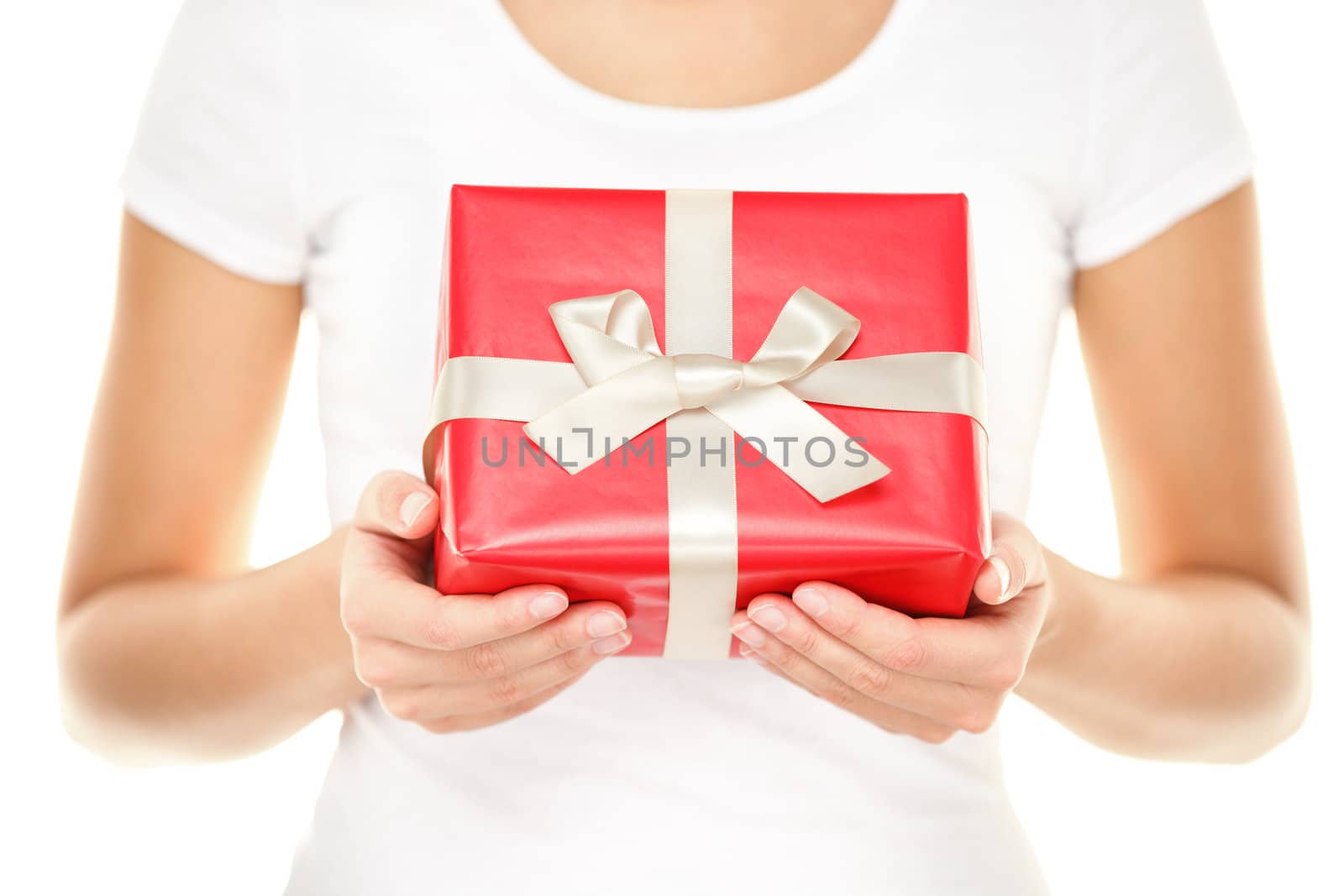 Gift / Christmas present. Woman showing and givng red gift with ribbon. Closeup of isolated on white background.