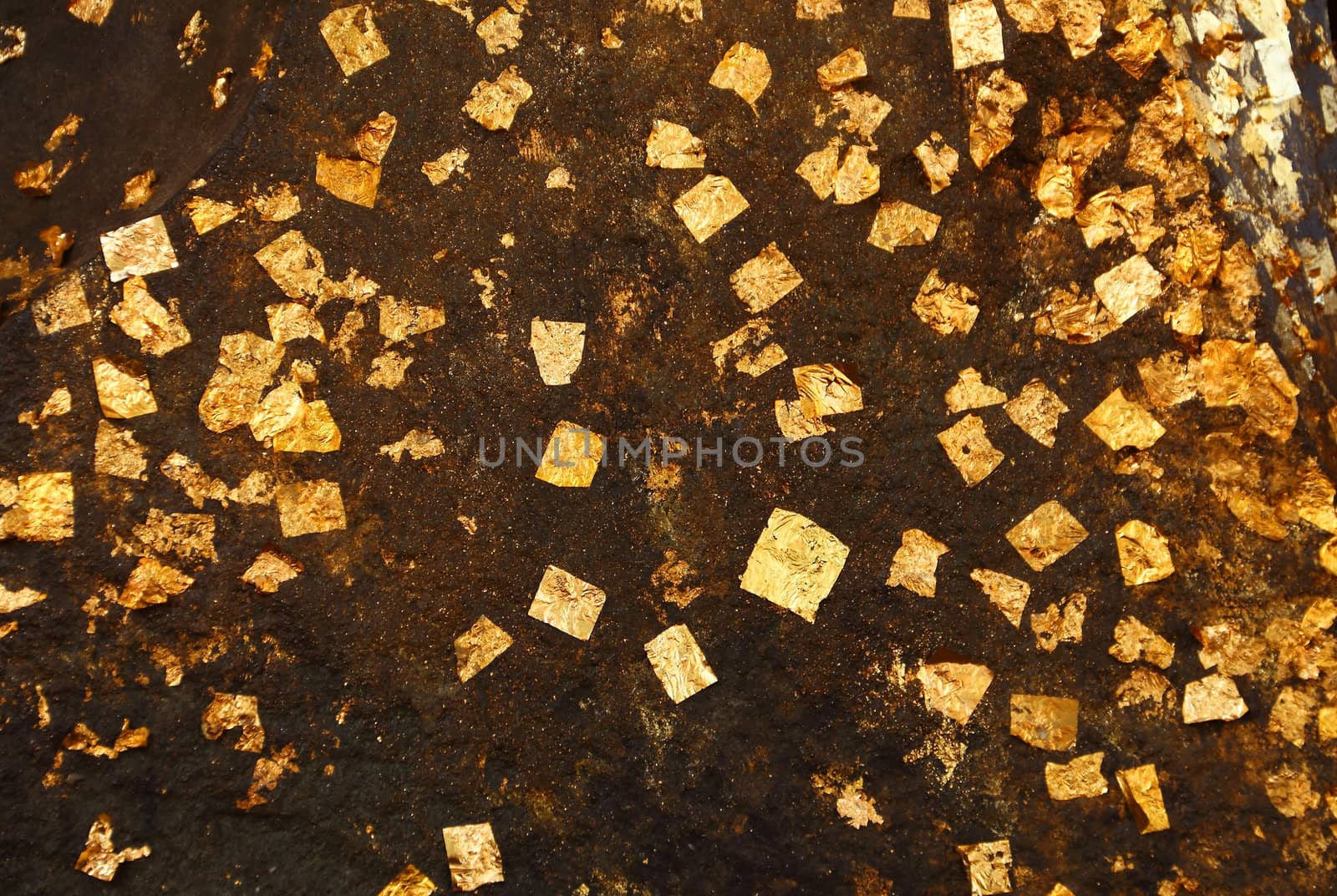 Close up gold leaves attached on the buddha statue, Ayutthaya, Thailand
