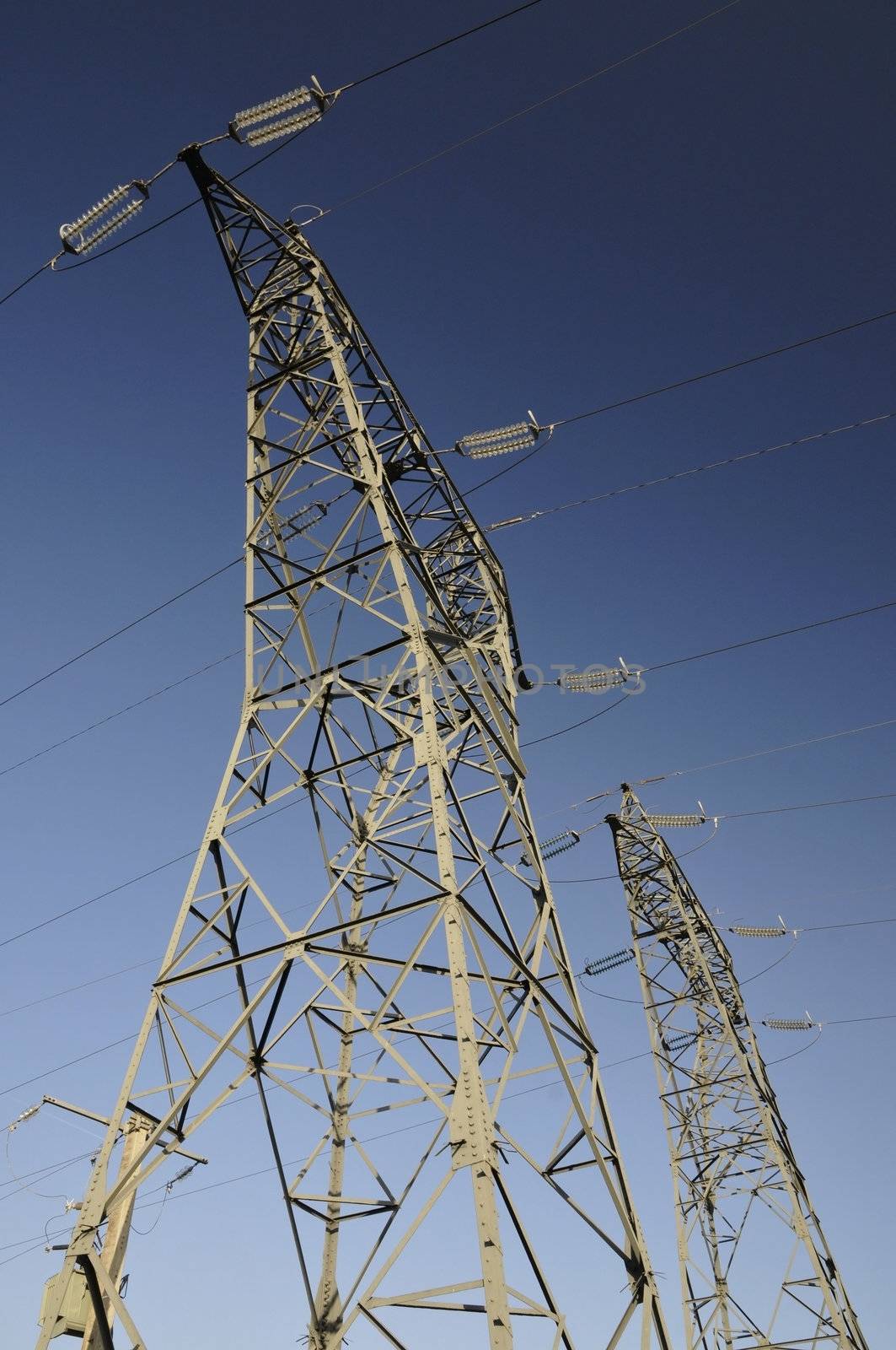 Two Big Electricity Pylons with a Blue Sky