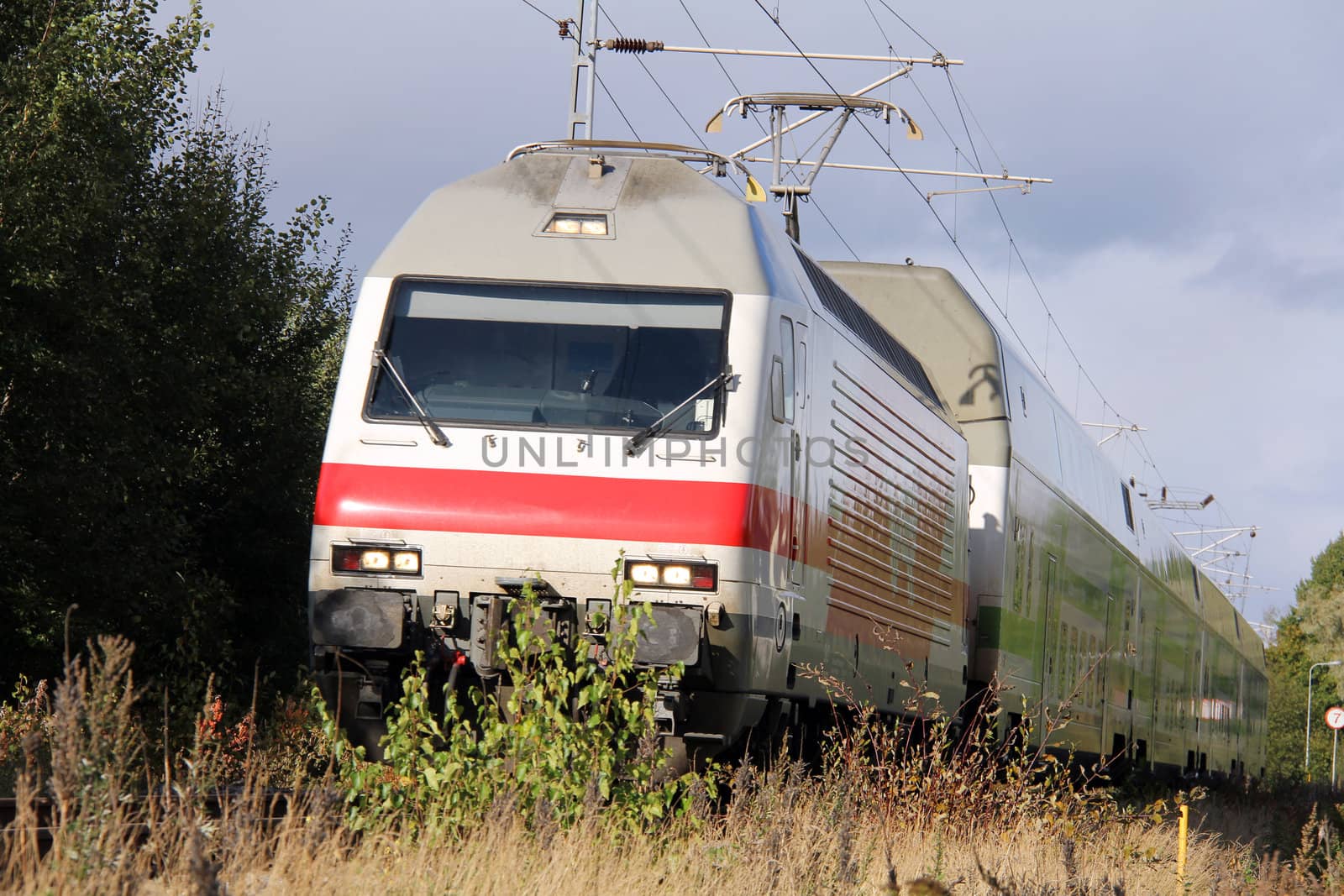 Fast moving modern electric train on a railroad.