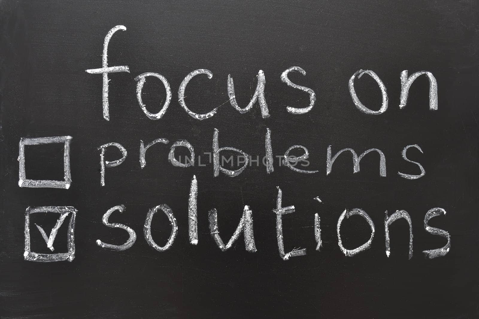 focus on solutions concept, handwritten on blackboard
