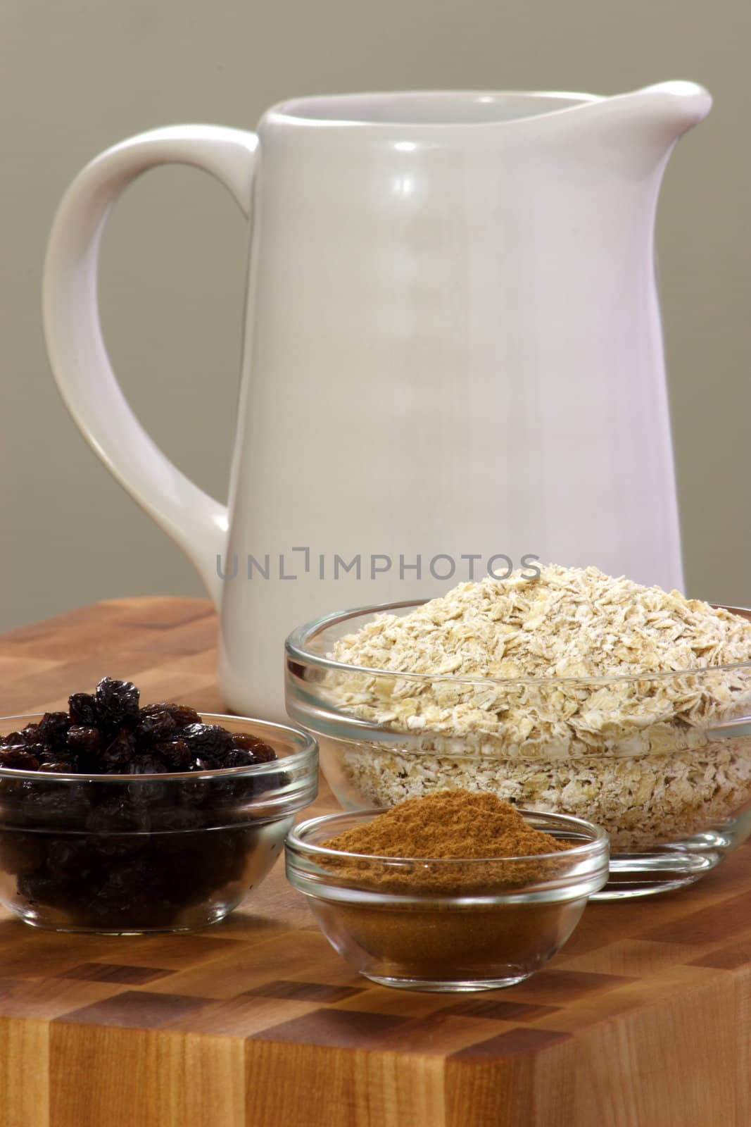 raw and healthy oat flakes with  raisins and other oatmeal ingredients that are  important on your daily nutrition to prevent high colesterol and heart dideases 