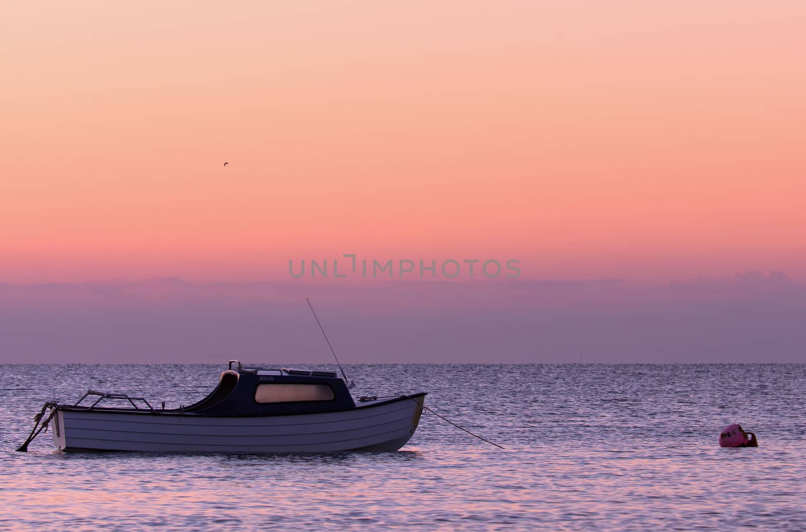 Small boat moored off the Kent coast at dusk
