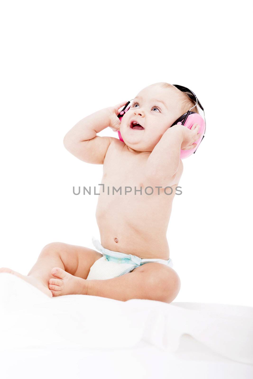 cute little baby with protection earphones isolated on white