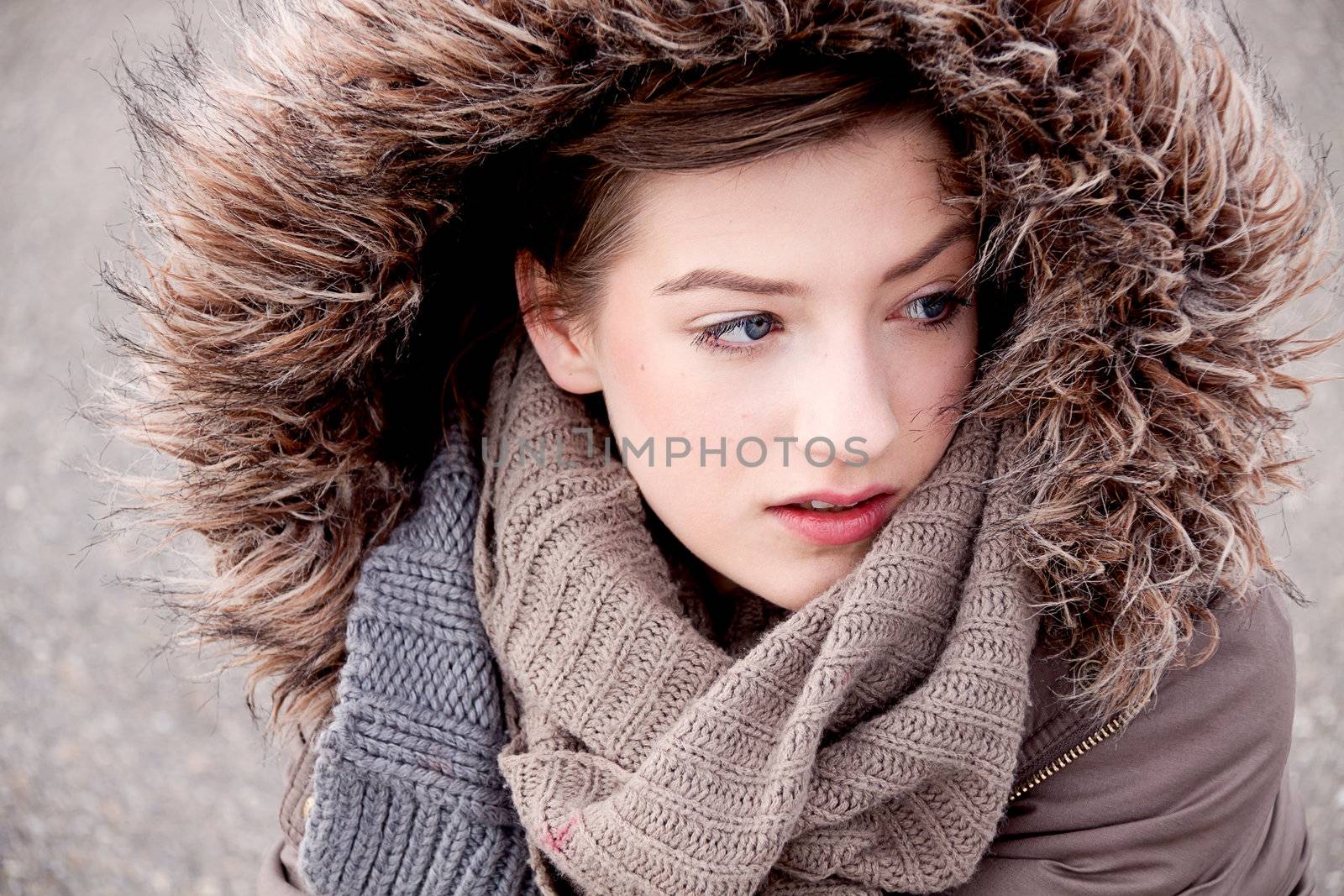 young woman with jacket coat and hood in winter outdoor 