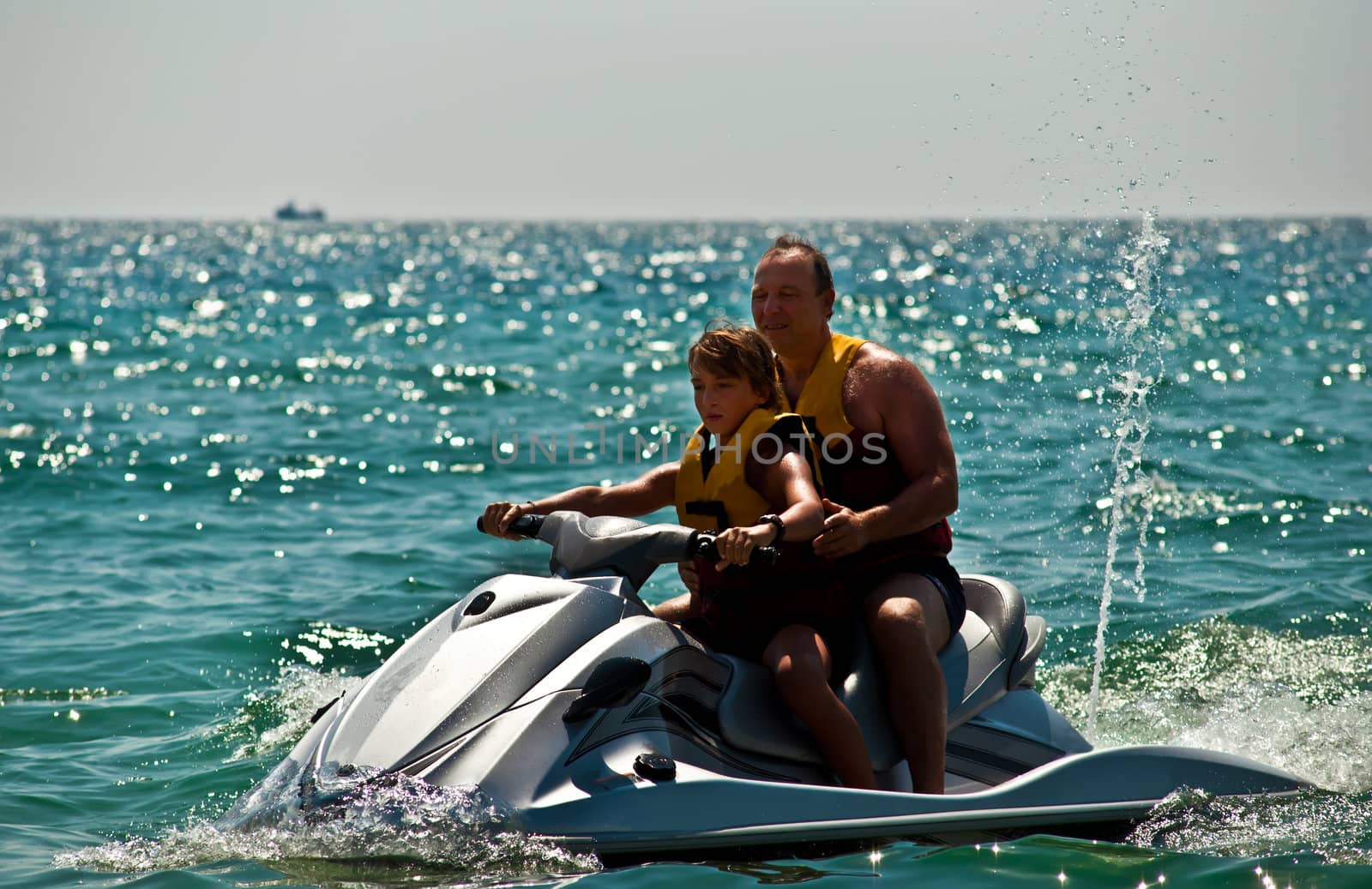 Happy family on the water in the sea .