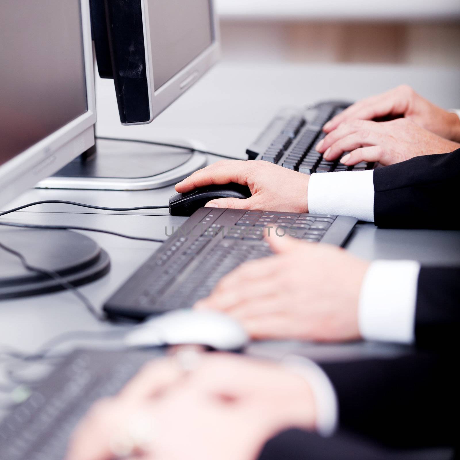 male hand on keyboard typing and scroll mouse on office desk