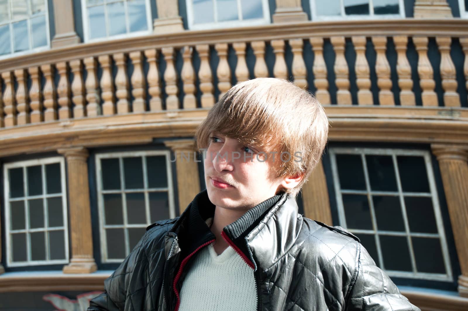 Portrait of a boy on a background of a historic building .