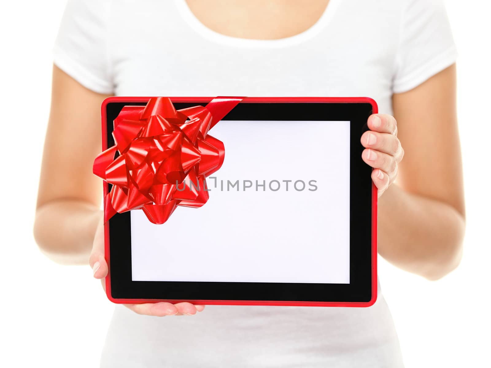 Tablet computer screen gift. Closeup of touch pad tablet computer screen with red gift ribbon. Christmas gift or present isolated on white background.