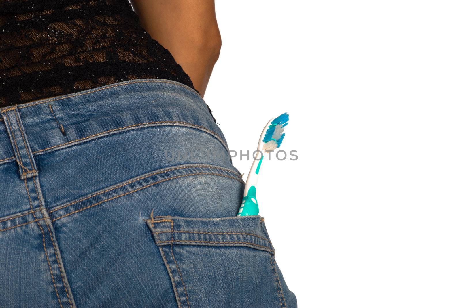 A toothbrtush in a jeans pocket