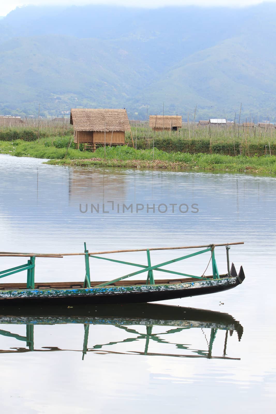 stilt house on lake by rufous