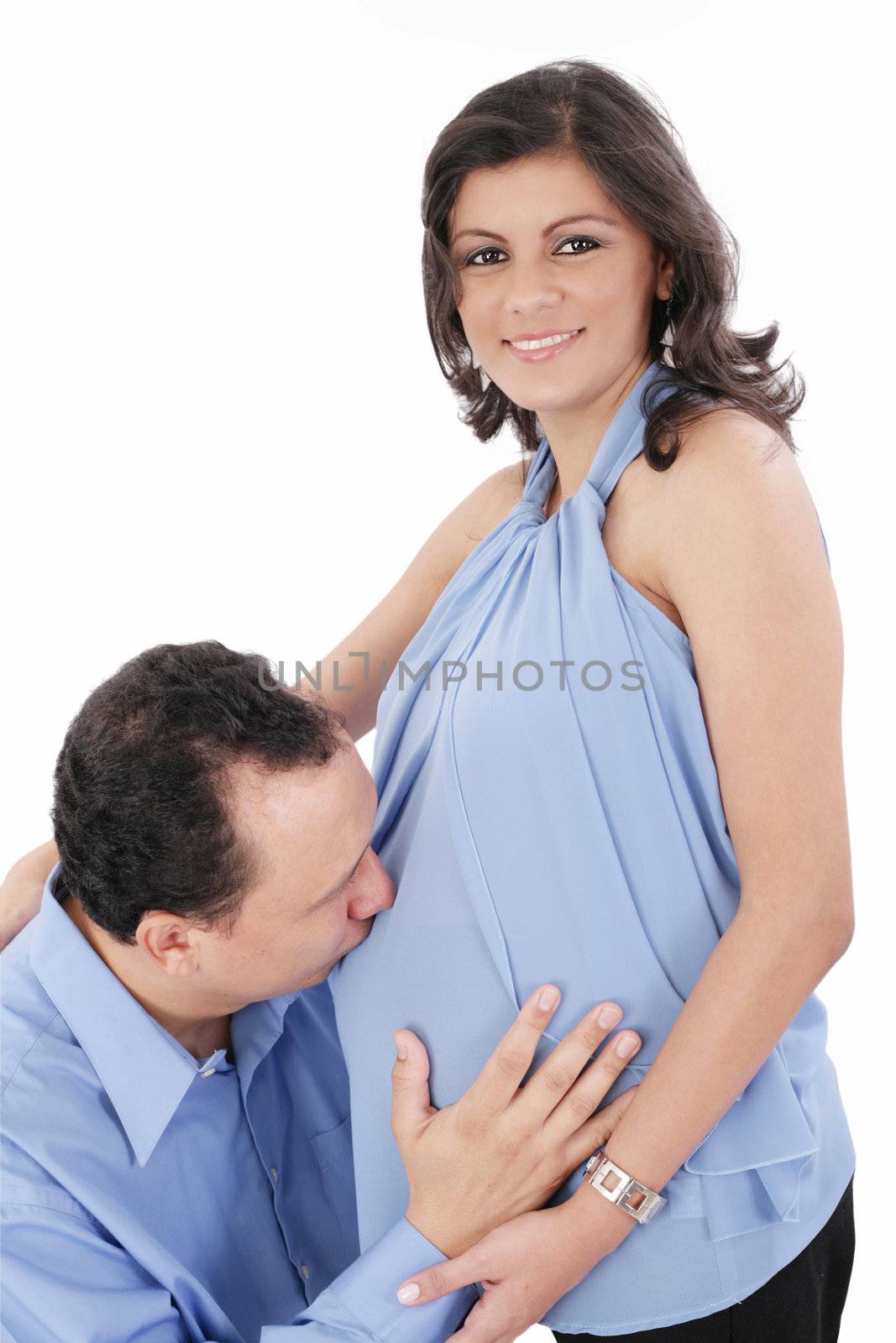 Father kissing pregnant belly of wife. Concept of love, over white background.