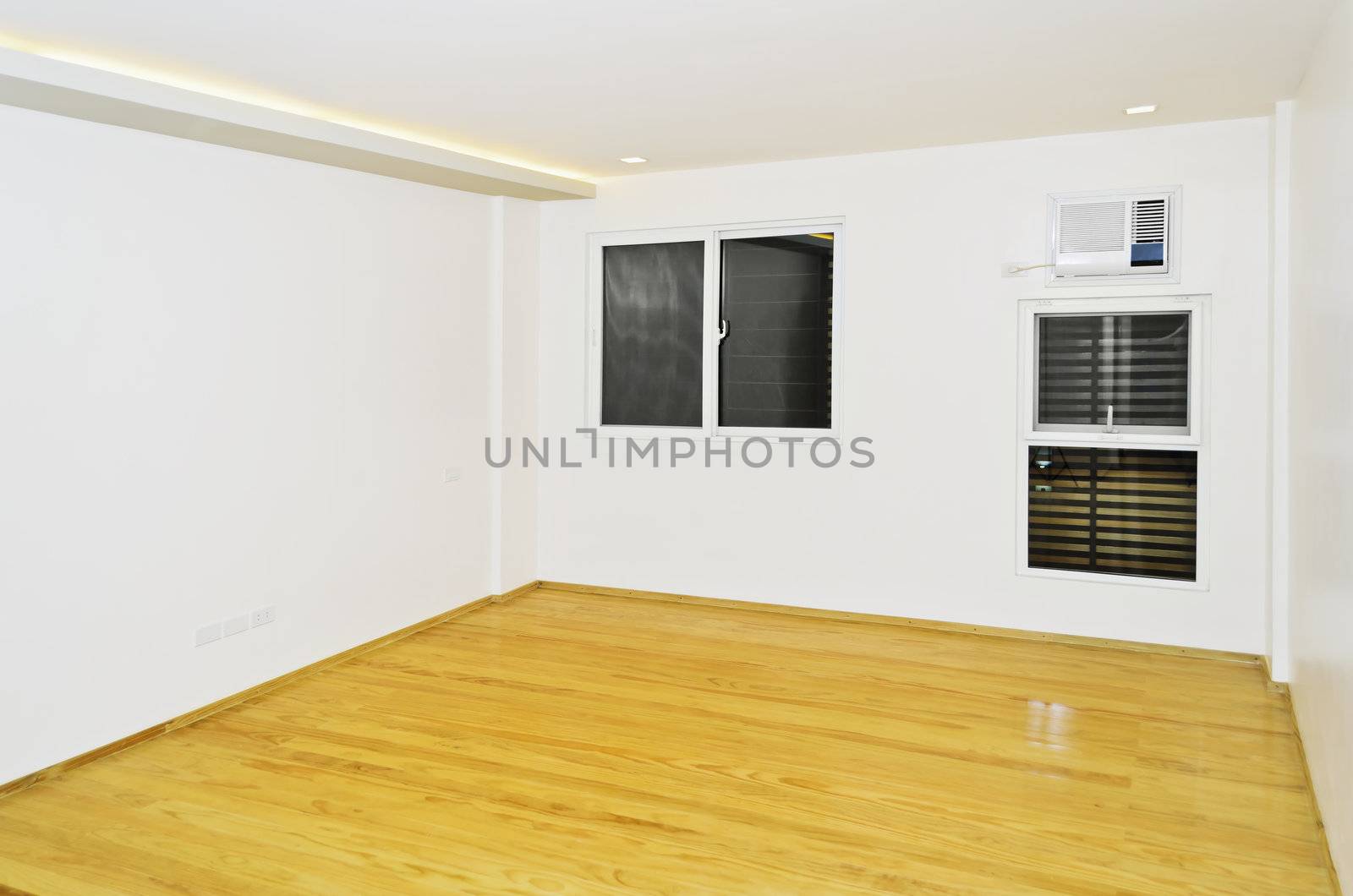 Newly built and painted white room with wooden flooring